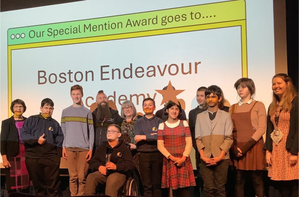 Pupils accept their award on stage